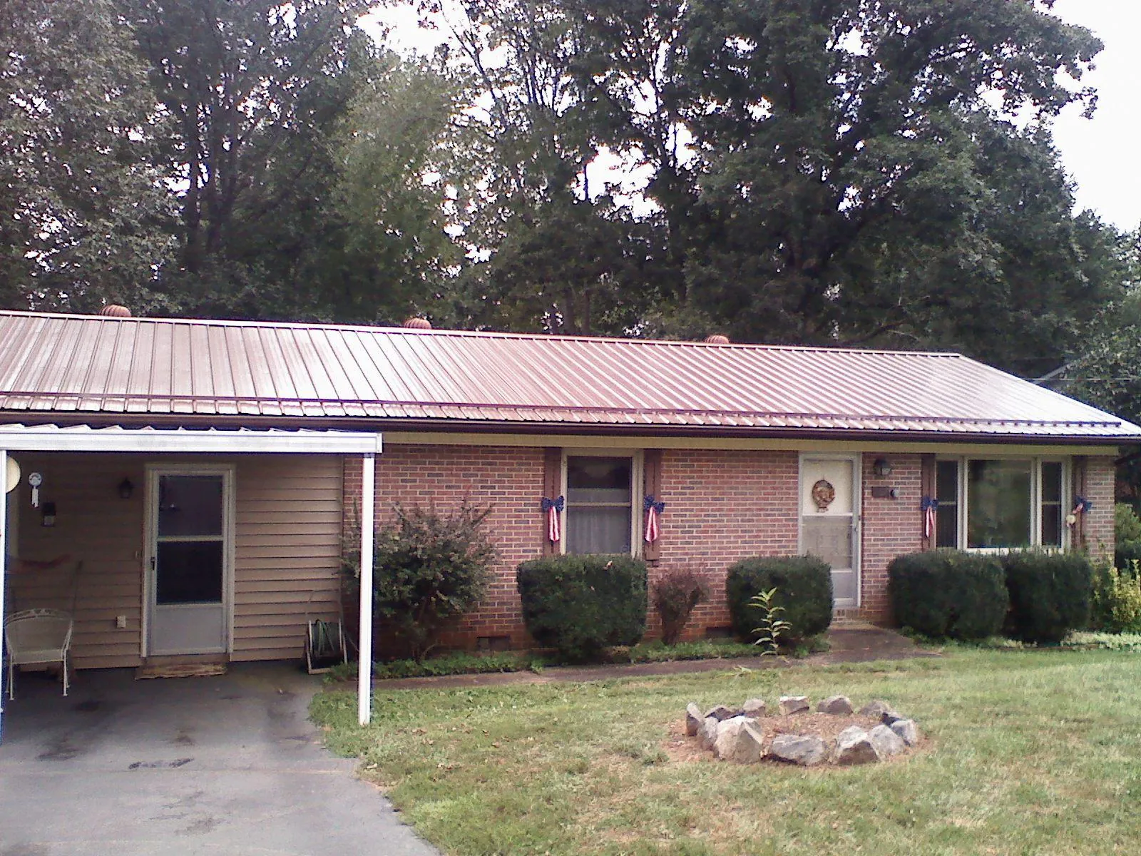 Bronze metal roof and carport on a brick ranch home — Roof Repair work by our crew in Bethel Park